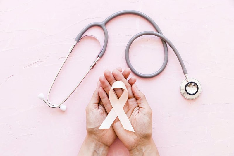 White awareness ribbon two hands with stethoscope pink background 1. Resolution and high quality beautiful photo