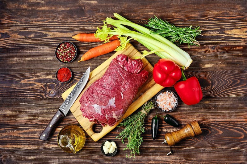 Overhead view of raw beef roll stuffed with vegetables for baking in oven
