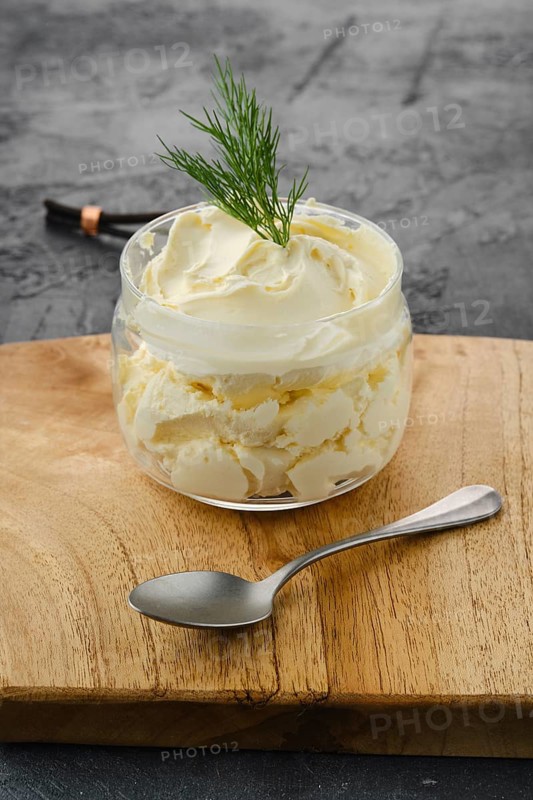 Closeup view of fat sour cream in a glass pot