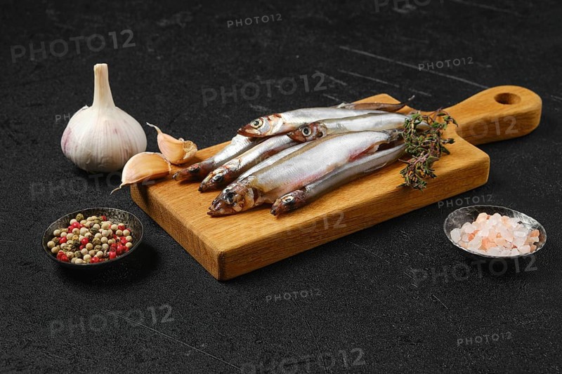 Pile of fresh raw frozen capelin