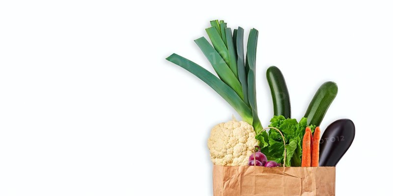 Paper bag with fresh vegetables isolated on white background