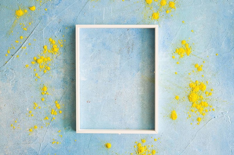 Yellow color powder around the white border frame on painted wall. Resolution and high quality beautiful photo