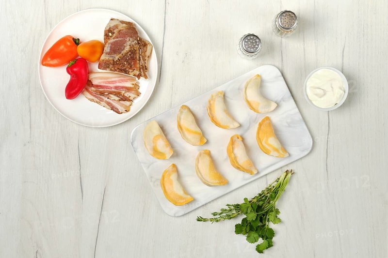 Top view of frozen dumplings with bacon and mashed potato