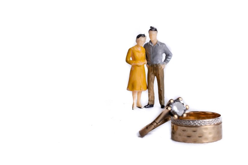 Couple on the phase of engagement with wedding rings on the foreground