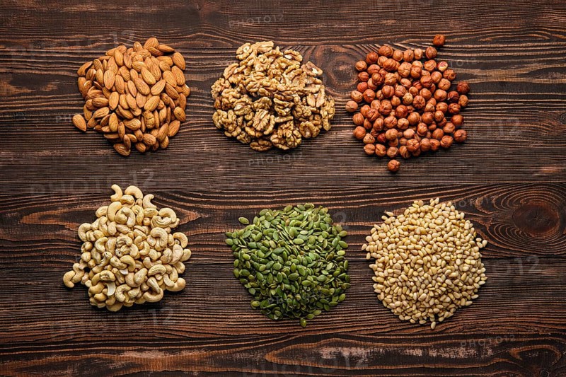 Assortment of nuts and seeds on wooden table