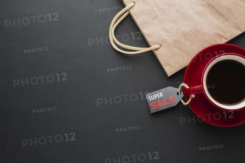 Discount paper bag with coffee flat lay