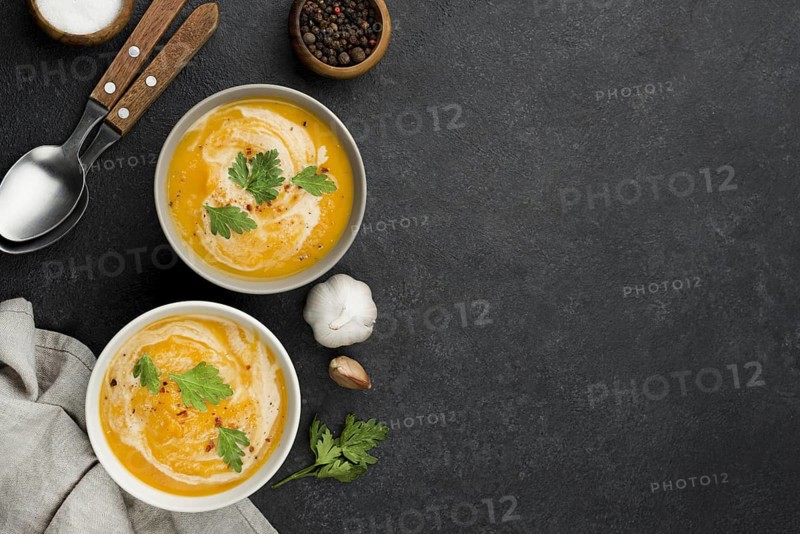 Flat lay delicious autumn soup composition with copy space