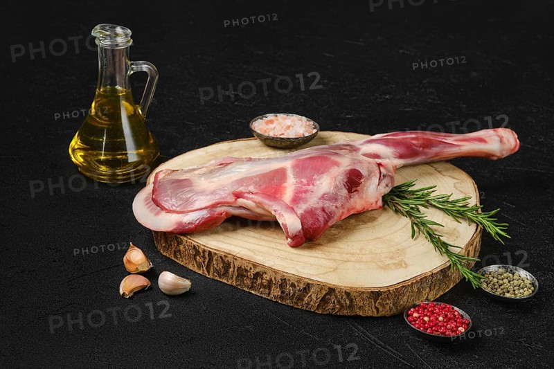 Raw fresh lamb shoulder on black background
