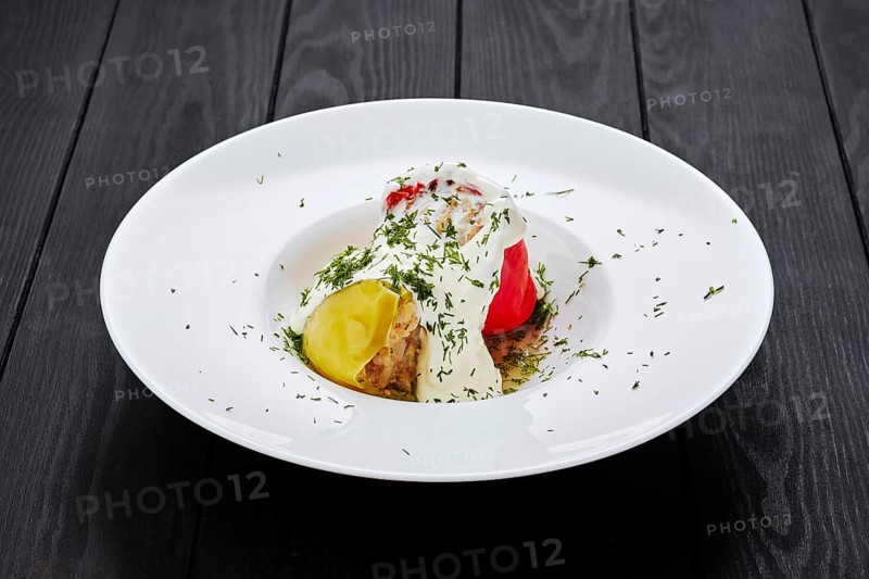 Bell pepper stuffed with minced meat on dark wooden table