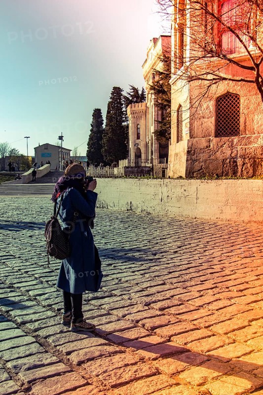 Tourist girl photographer with dslr camera outdoor in city street