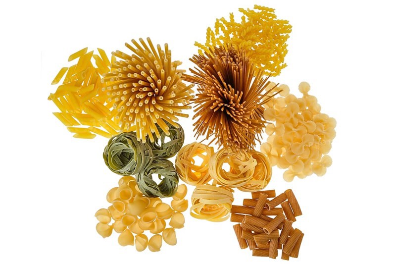Overhead view of various kinds of pasta isolated on white background