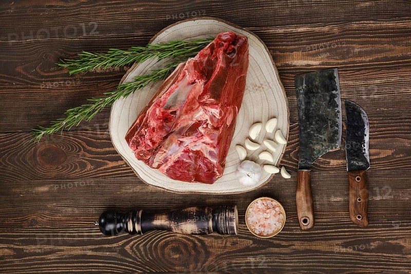 Raw fresh beef shank cross-cut on wooden background