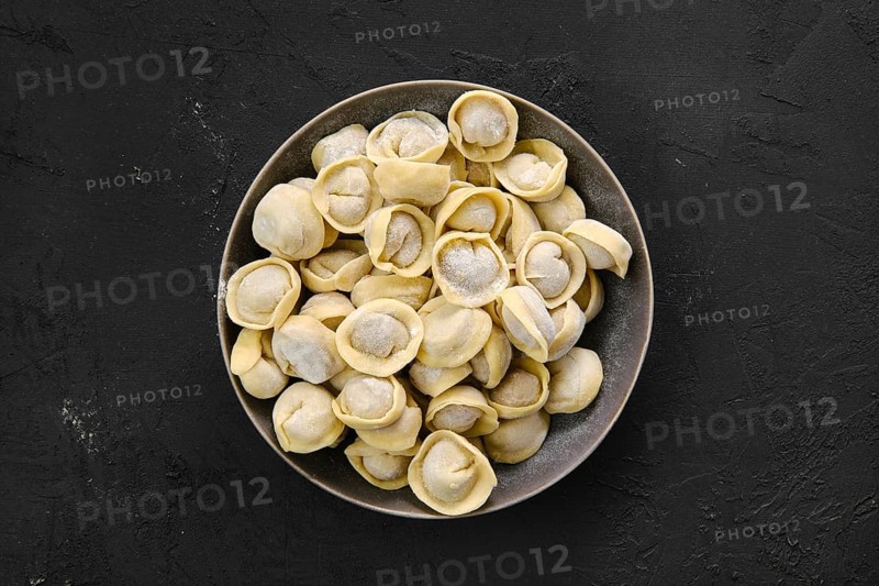 Top view of homemede meat dumplings on on black background