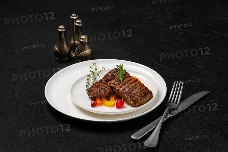 Two grilled steaks on a plate