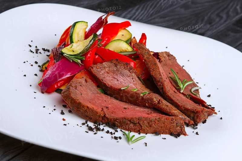 Roasted beef cutted on slices with grilled bell pepper