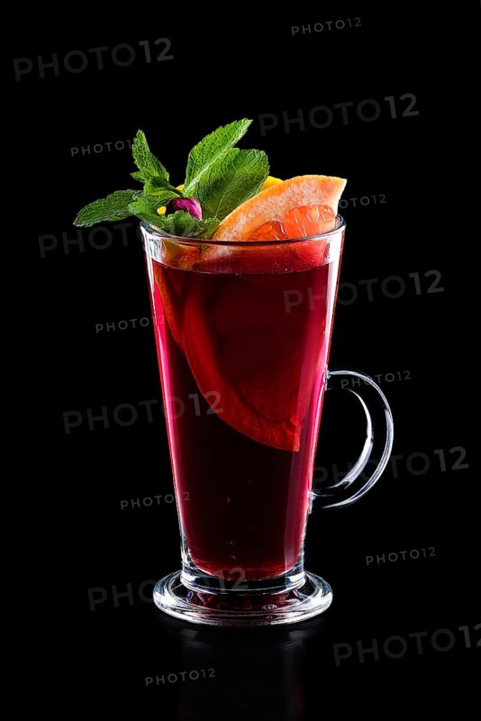 Glass of hot rose tea with grapefruit and mint isoalted on black.