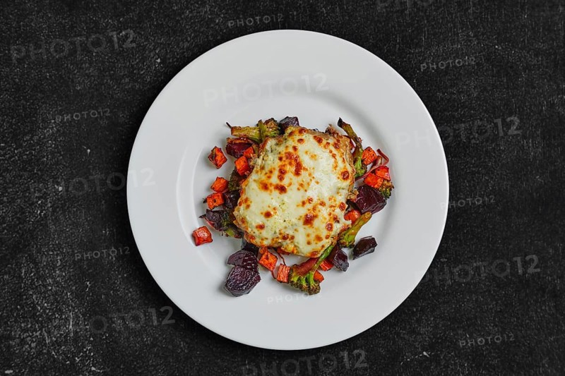 Top view of cod fillet baked with cheese topping served with fried beet