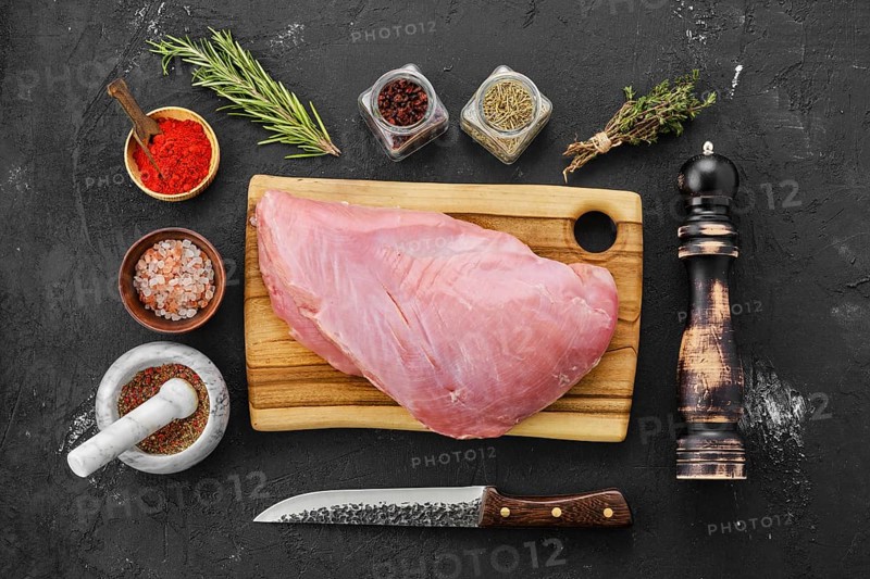 Top view of raw fresh turkey breast with spices