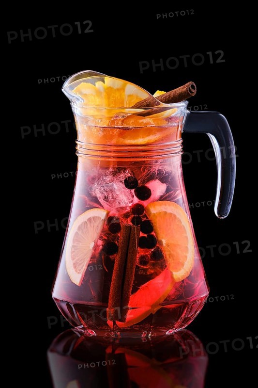 Pitcher with cold sangria isolated on black background