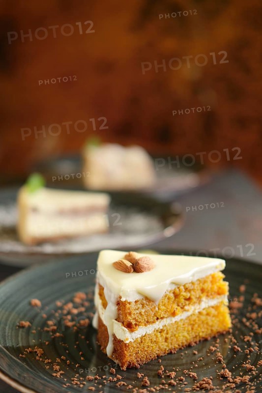 Three pieces of homemade cakes on a dark wooden vintage background