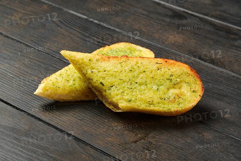 Two pieces of garlic bread on a table