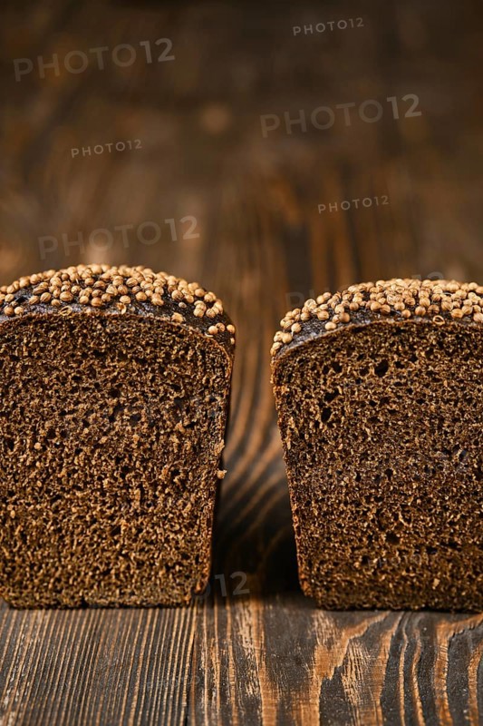 Closeup view of fresh rye brown bread on wooden cutting board