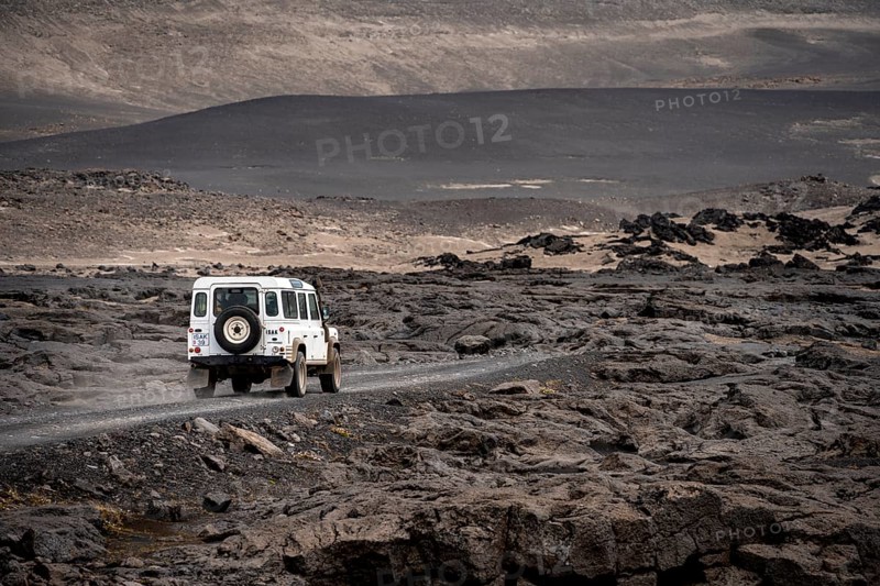 White Land Rover on a dirt road