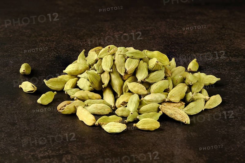 Pile of cardamom on abstract background