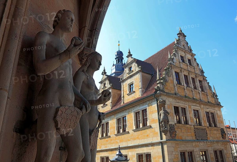 The figures of Adam and Eve on the main portal of the church of St. Moritz and the building of the Casimirianum grammar school