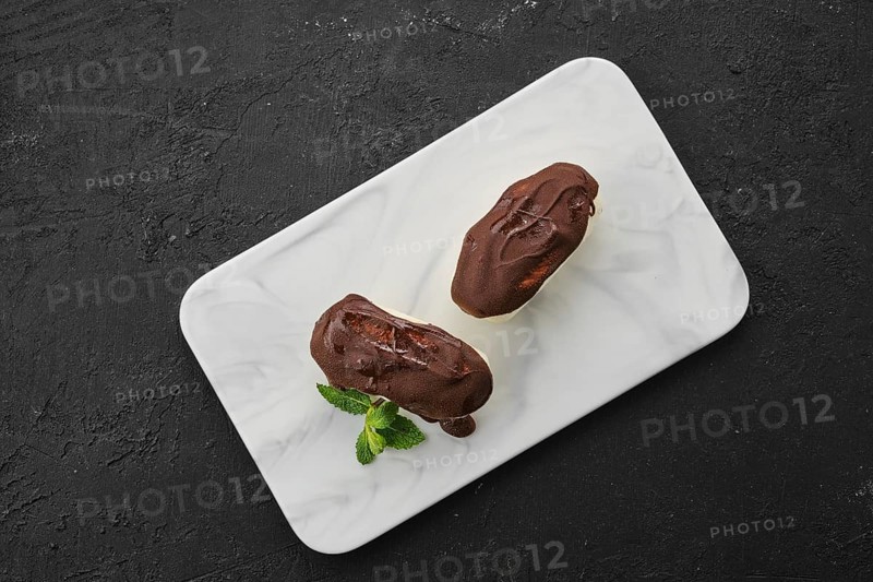 Top view of glazed curd with chocolate on marble plate