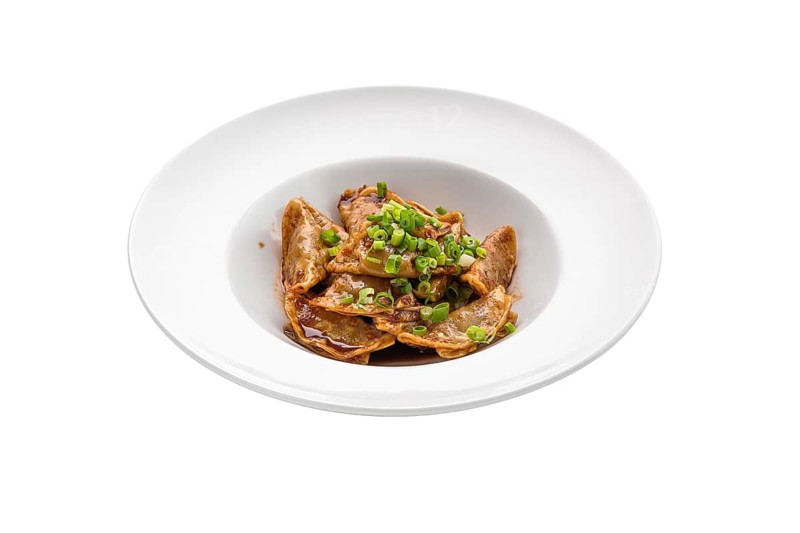 Deep-fried japanese gyoza or dumplings snack with soy sauce isolated on white background