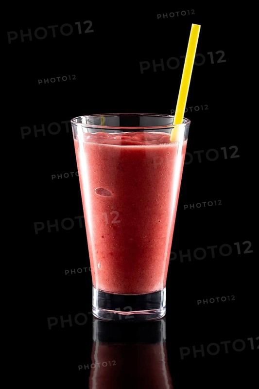 Glass of fresh cold smoothies with straw isolated on black background