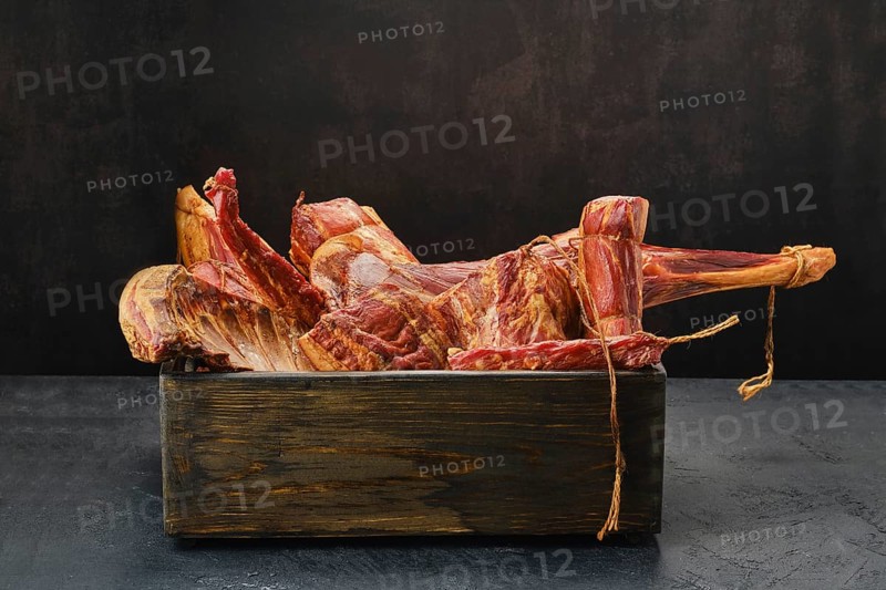Assortment of air dried and smoked lamb and beef meat in wooden box