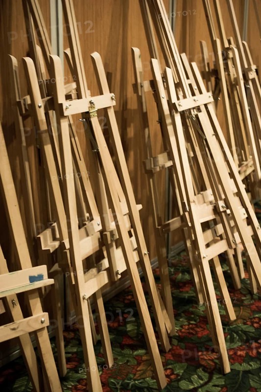 Dozens of of wooden easels in a room