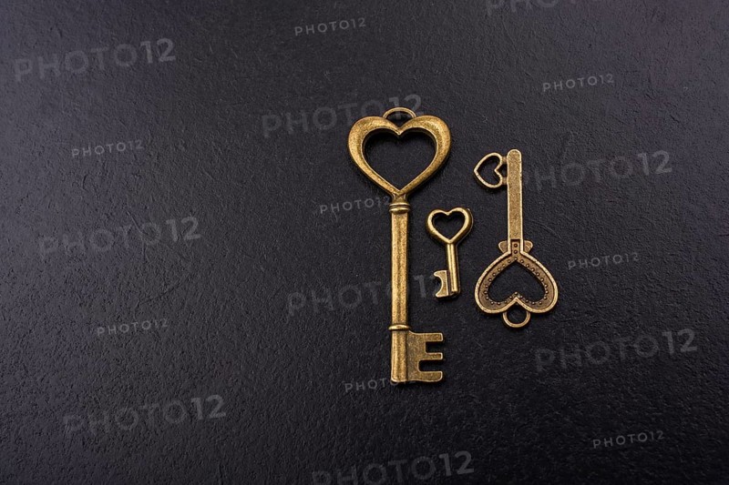 Heart shaped retro metal keys on dark background