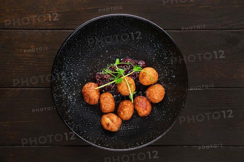 Plate with traditional scandinavian meatballs with cranberry sauce