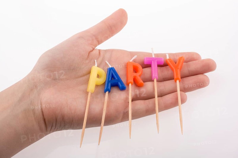 Color candles in hand on sticks write the word party
