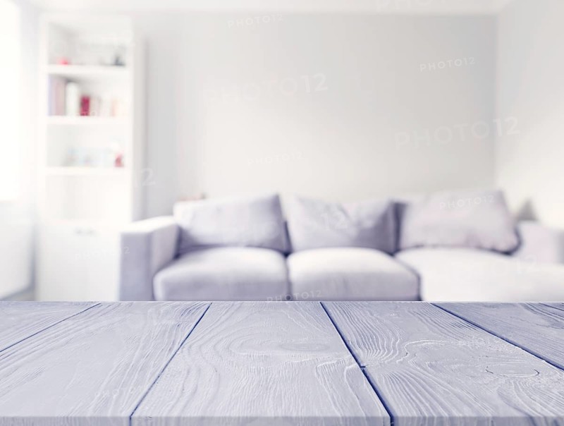 Gray wooden table front blur white sofa living room