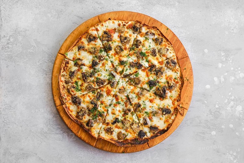 Thin-crust pizza dough with mushrooms and lot of melted cheese