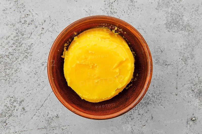 Homemade rustic melted butter and small cast iron skillet