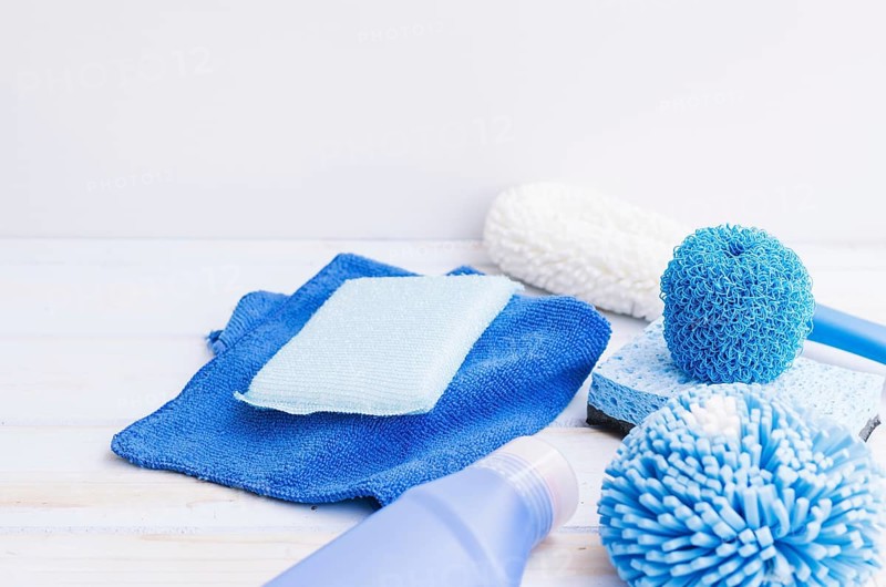 Close up blue cleaning supplies desk