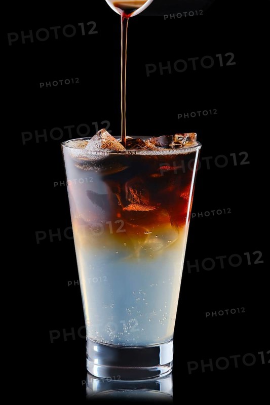 Pouring puer in tonic refreshing drink isolated on black background