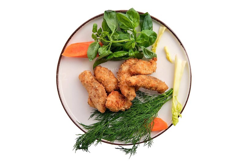 Chicken nuggets in breading isolated on white background