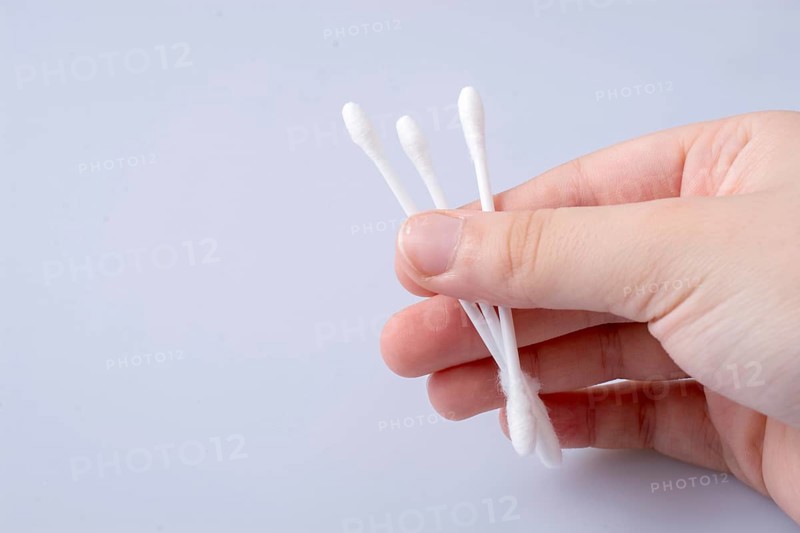 A few ear sticks in hand isolated on white background