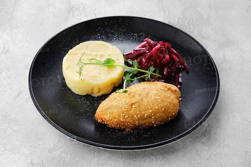 Kiev citlet with mashed potato and pickled beetroot on a plate