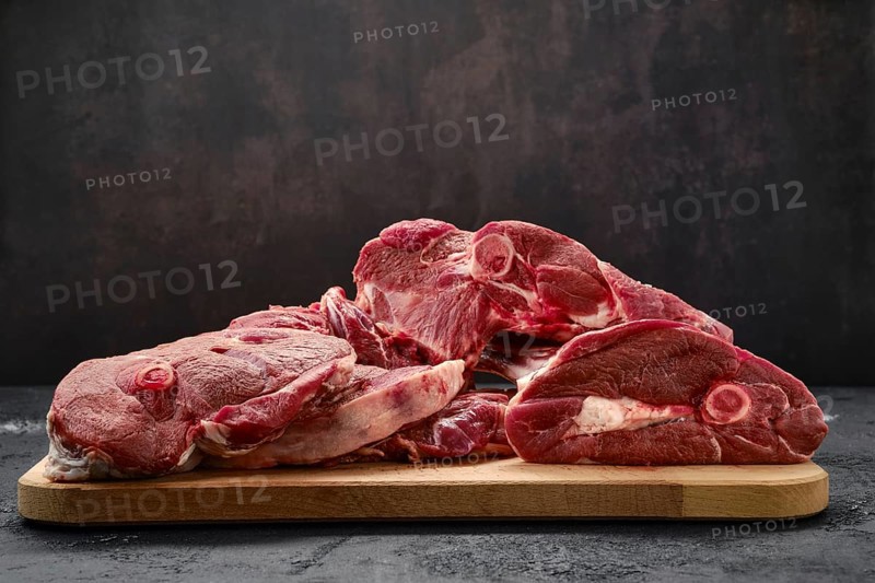 Assortment of raw fresh lamb meat on wooden tray