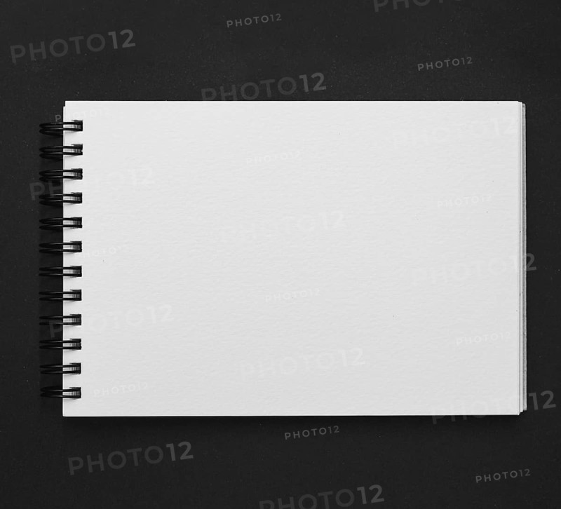 Elevated view spiral notepad black background