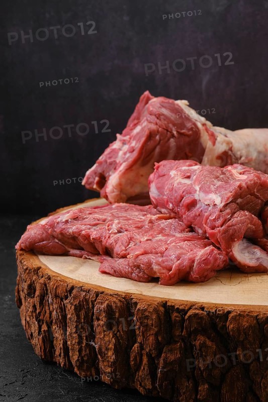 Chopped pieces of fresh lamb neck on cutting stump