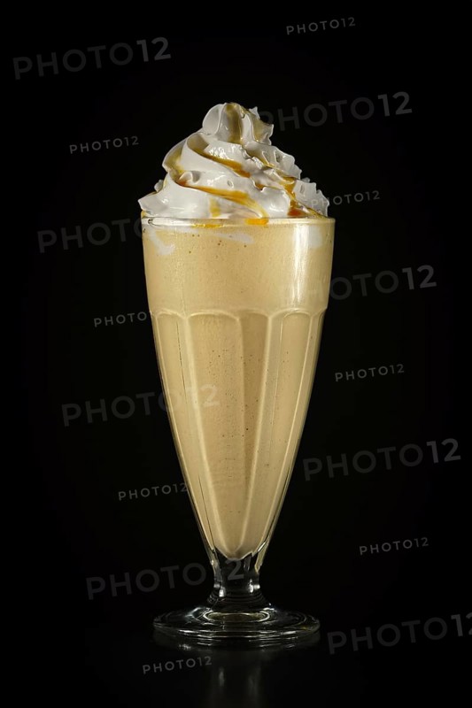 Glass of fruit cocktail on black background