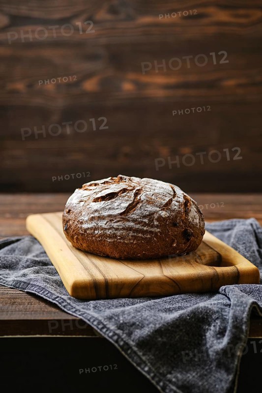 Fresh rye brown bread on wooden cutting board